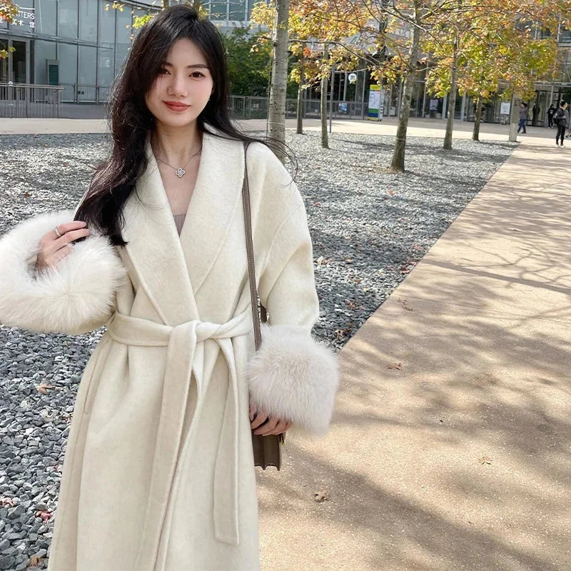 Long belted women's coat with faux fur sleeves