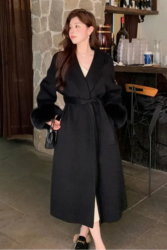 Long belted women's coat with faux fur sleeves