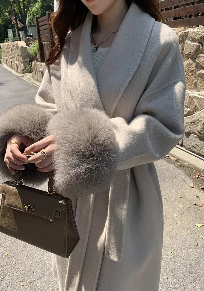 Long belted women's coat with faux fur sleeves